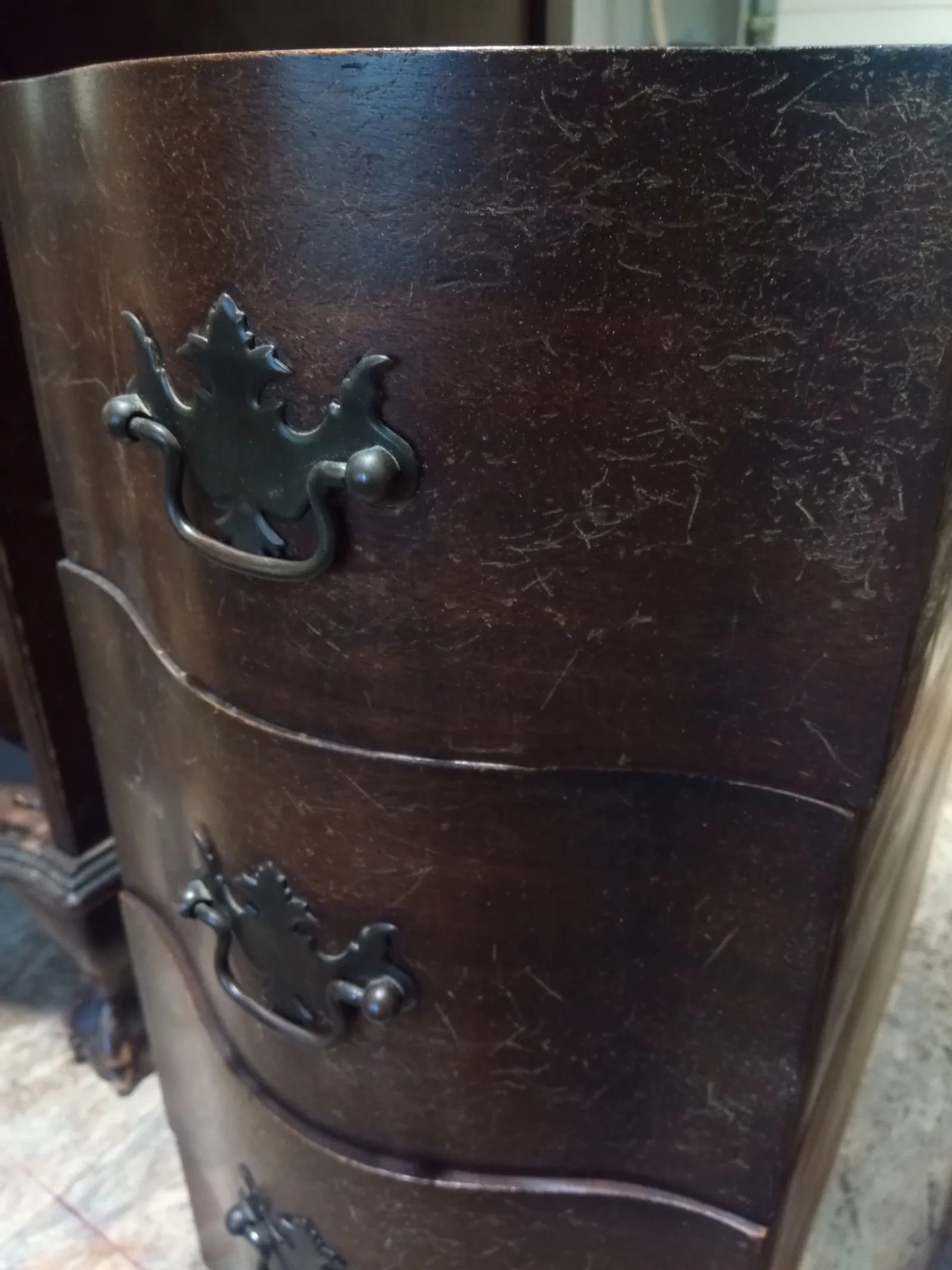 Detail poškozeného rohu komody před opravou